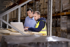 warehouse manager checks something with his supervisor