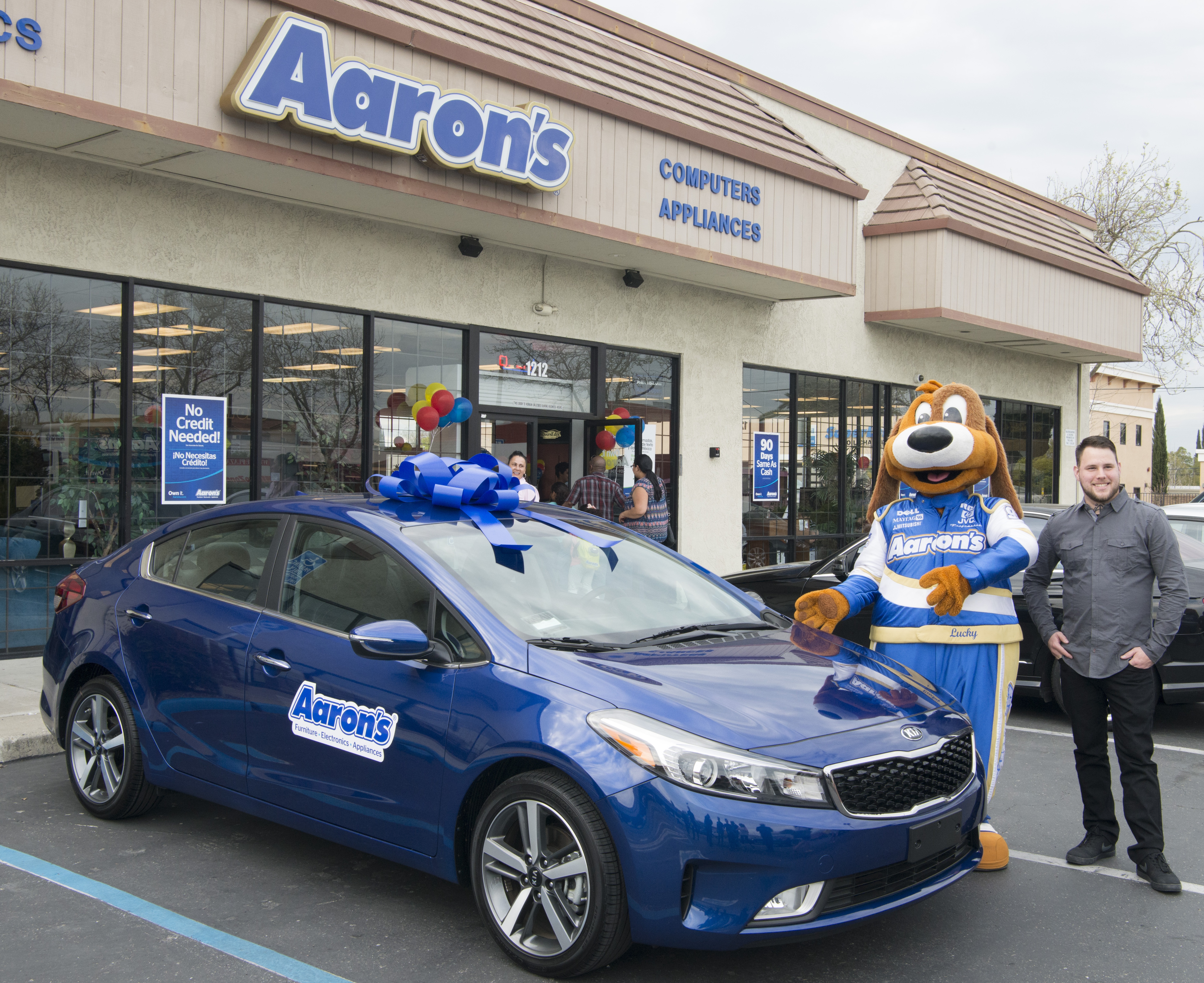 Winner of Aaron's Big Blue Bow Kia Giveaway Adam Barbour receives his 2017 Kia Forte at the Aaron's store in Tracy Calif., on Wednesday, March 15, 2017. (Peter Barreras/AP Images for Aaron's, Inc)