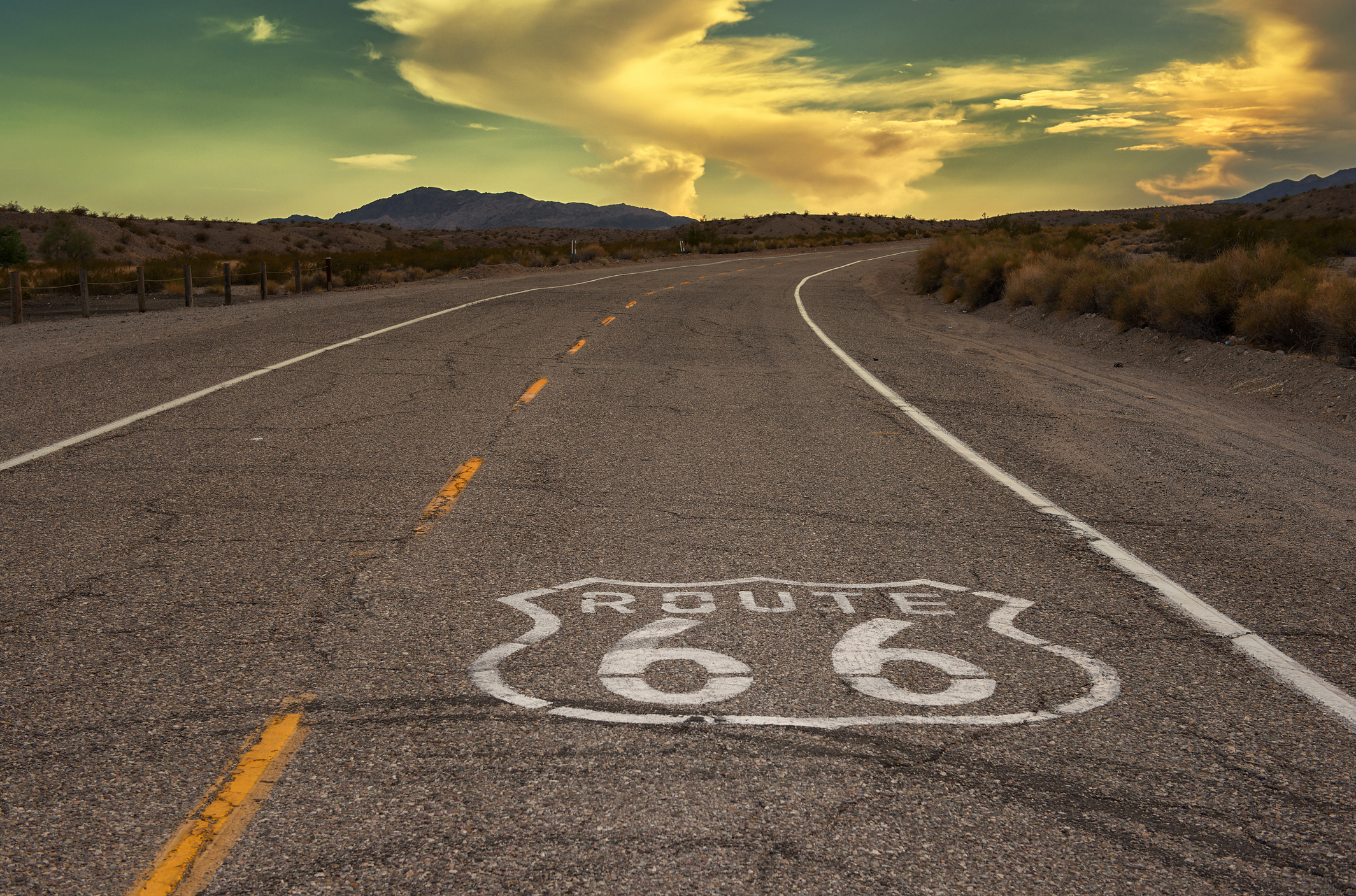California: Historic Route 66 with marker on road at sunset - APRO