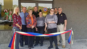 From left to right: Store Manager Krista McGuire, Sales Manager Litissa Mason, Regional Manager Dave Dafoe, Customer Account Representative Walter Lawhorn, President of the North Regional Chapter of the Chamber of the Commerce Pam Whittle, and Finance and Human Resource Kim McKinley and Starke local police officer.