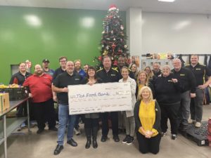 MRDA members present a check to the food bank.