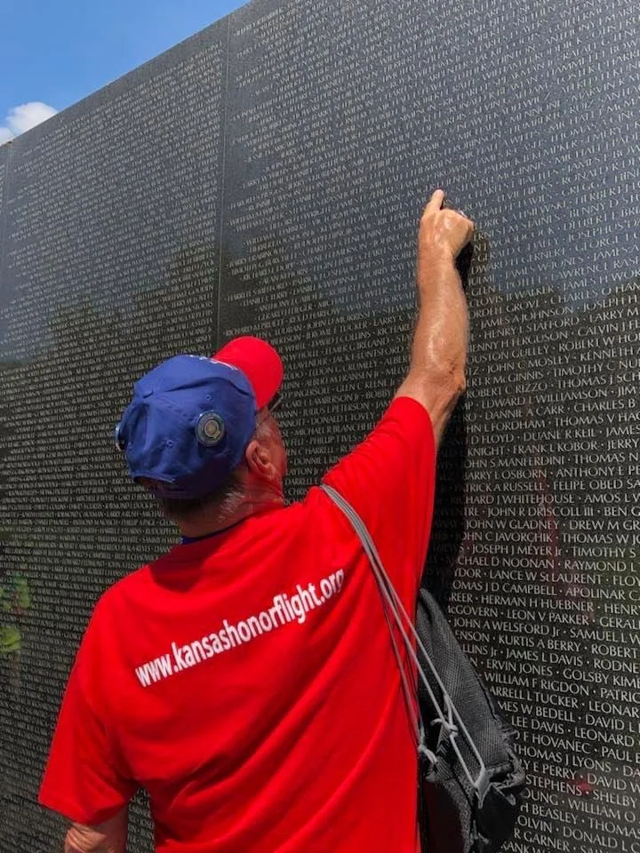 Veteran from Kansas visits the Vietnam Veterans Memorial in Washington DC, part of the Kansas Honor Flight experience.