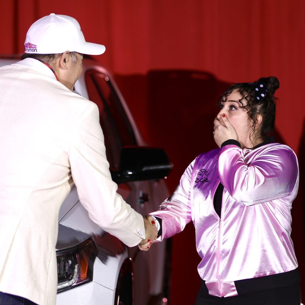 R2O Owner & President Mike Tissot (L) presents keys to a new car to a overwhelmed and overjoyed employee Kristina Bailey (R).