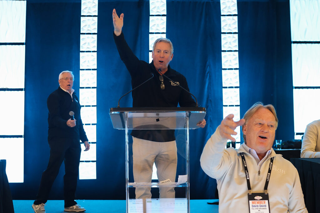 Lyn Leach calling out “Sold, Sold, Sold!” during the HOT Show with Dennis Shields and David David joining him on stage.