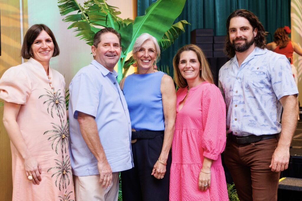 The Carrico family of five stand together smiling. 