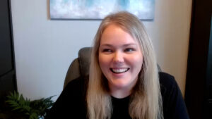 Smiling woman wearing a black shirt.